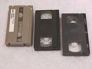 Three different VHS-family video cassettes. Fr...